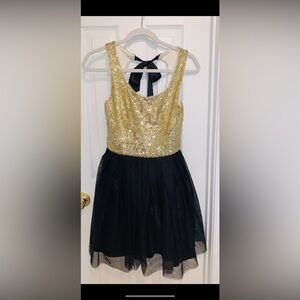 Brand new. Gold sequin and blank tulle dress. Keyhole back. Ties at neck in back
